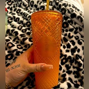 Golden orange Starbucks cups